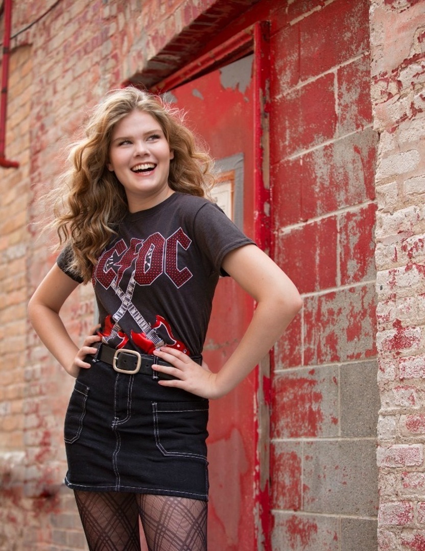 high school senior girl in ac/dc shirt smiling