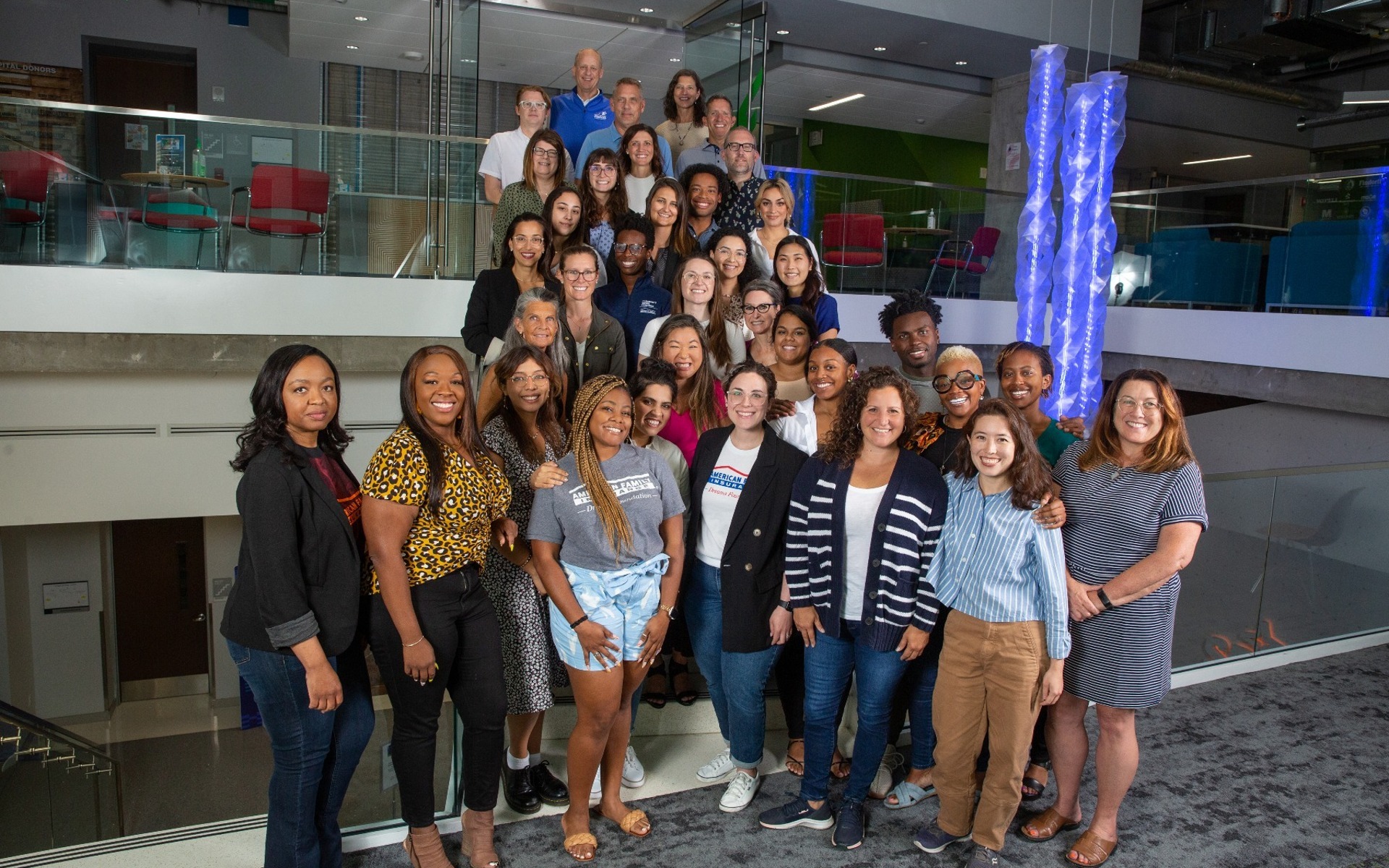 large business group poses on a staircase at American Family Insurance Institute