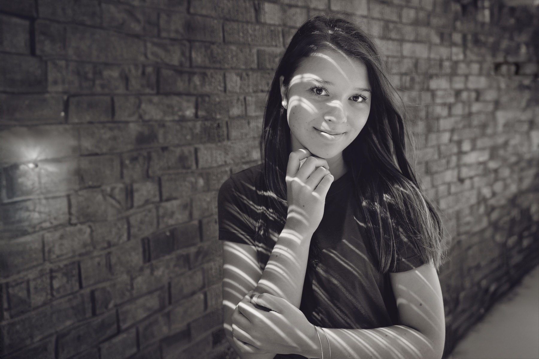 hs senior girl poses with shadowed lines across her face