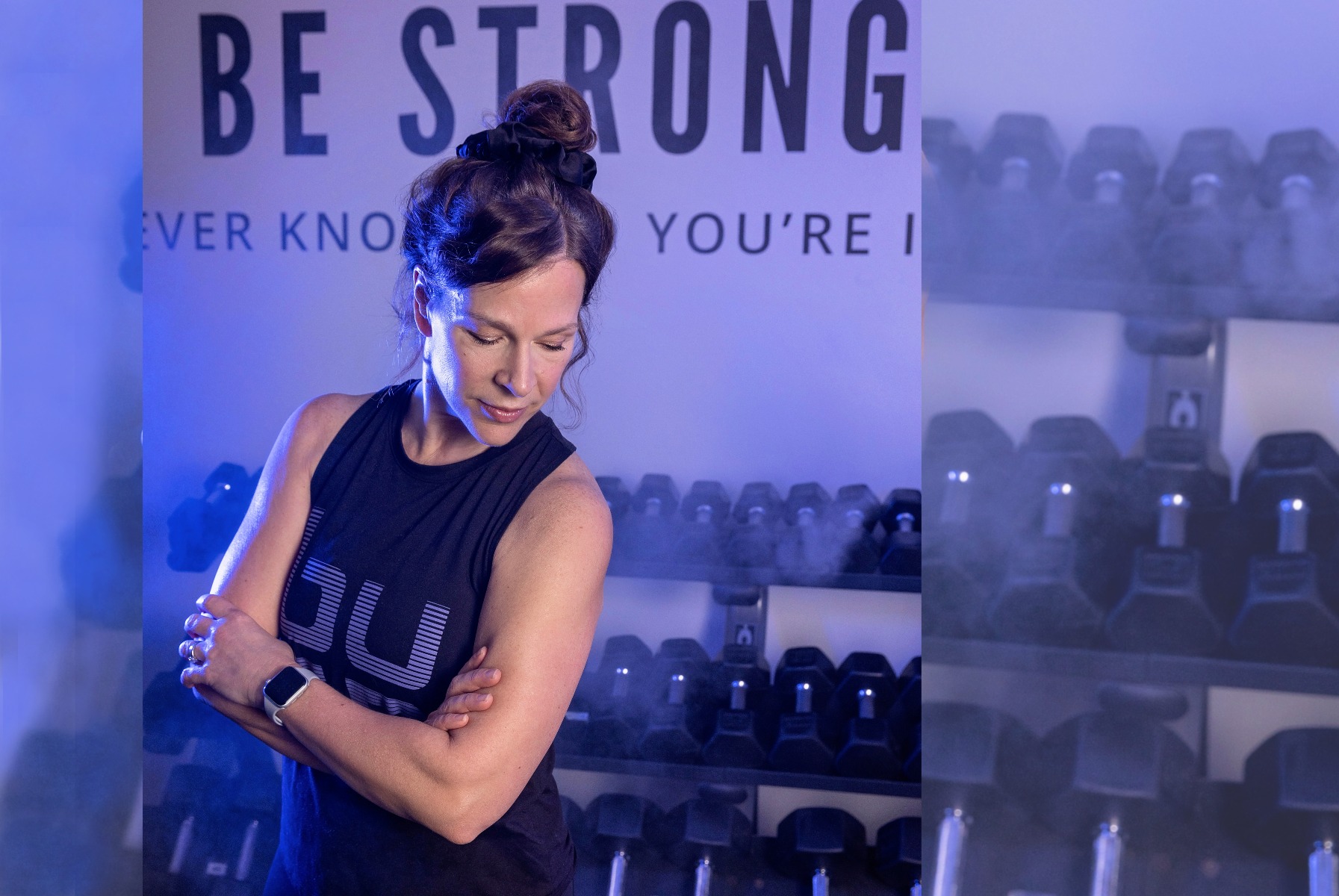 burn boot camp member poses in the weight room