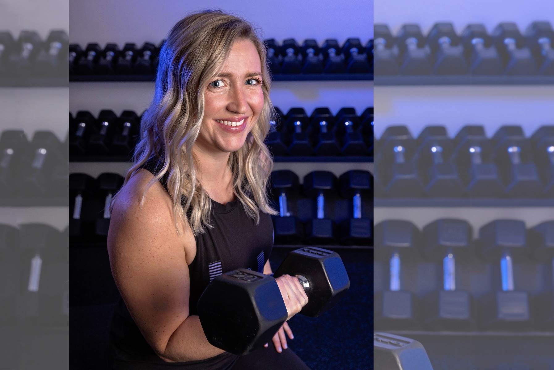 burn boot camp member poses with a free weight